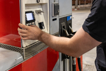 Man Refueling a Car at Gas Station