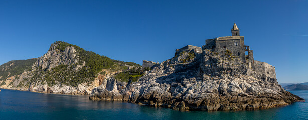 Panoramic view of the Ligurian coast and the colorful villages of Cinque Terre as seen from the sea on a cruise ship on a clear day. Cinque Terre, Liguria, Italy