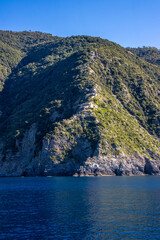 Panoramic view of the Ligurian coast and the colorful villages of Cinque Terre as seen from the sea on a cruise ship on a clear day. Cinque Terre, Liguria, Italy