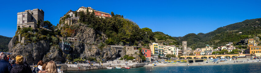 Panoramic view of the Ligurian coast and the colorful villages of Cinque Terre as seen from the sea on a cruise ship on a clear day. Cinque Terre, Liguria, Italy