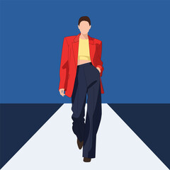 Woman in red blazer walking on a runway during a fashion show event