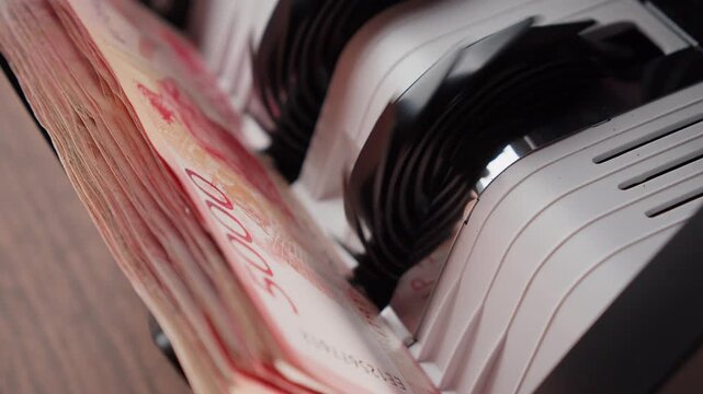Russian rubles in a money counting machine &mdash; finance and economy concept