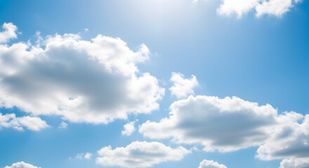 Beautiful blue sky with fluffy white clouds on a sunny day, creating a peaceful scene