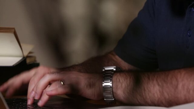Close-up of hands comparing an old book and typing rapidly on a modern laptop. Blending history, research, and digital workflow.