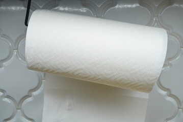 Close-up of a paper towel roll hanging in a kitchen setting