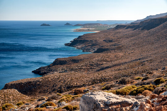 Coastal landscape near Kato Zakros, Crete, Greece, showing rocky cliffs and deep blue Mediterranean sea with scenic coastline under clear bright sky