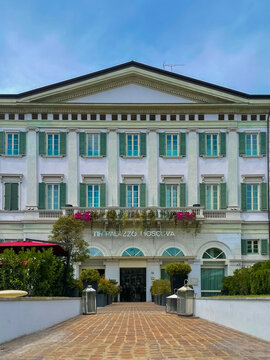 Architectural Grandeur: An elegant building with classic architectural details stands tall, its facade adorned with symmetrical windows, inviting doorways, and a sense of timeless charm.