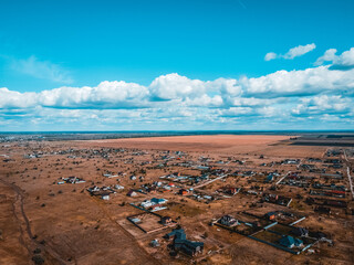 Vast Landscape: An aerial perspective reveals a sprawling landscape. Homes are scattered across the...