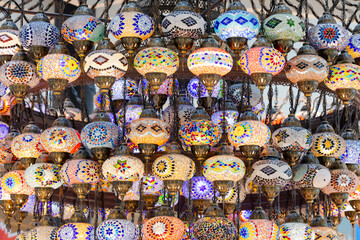 A large number of oriental lamps hang together suspended from the ceiling.
