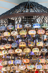 A large number of oriental lamps hang together suspended from the ceiling.