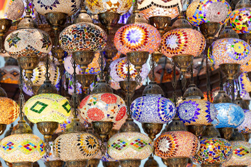 A large number of oriental lamps hang together suspended from the ceiling.