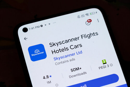 Warsaw, Poland - November 6, 2025: A close-up view of a smartphone screen displaying the Skyscanner app, showcasing options for flights, hotels, and car rentals, featuring a rating of 4.8 stars.