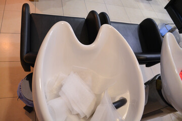 A modern hair salon interior with black chairs, large mirrors, and minimalist decor. Concept for a beauty salon professional's workspace, modern customer service