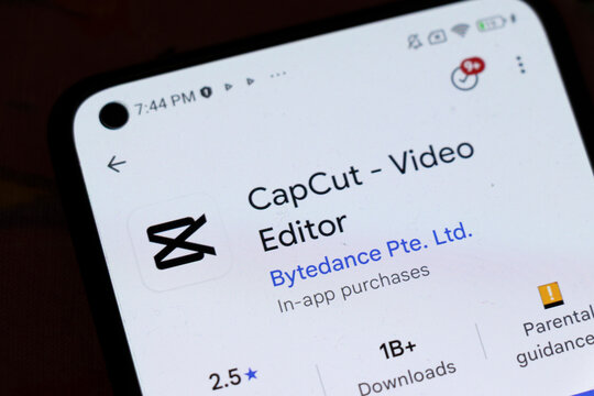 Warsaw, Poland - November 6, 2025: Close-up of a smartphone screen displaying the CapCut video editor app. The interface shows download statistics and ratings.