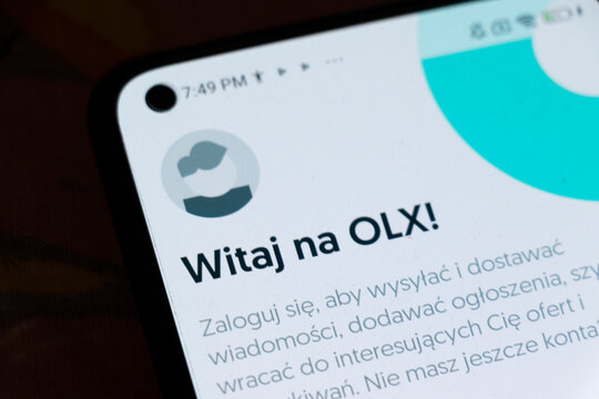 Warsaw, Poland - November 6, 2025: Close-up of a smartphone screen displaying the OLX app interface. The screen shows a welcoming message with user instructions.