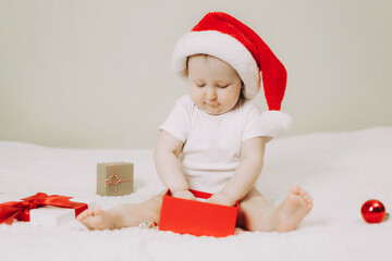 Adorable Baby in Santa Hat with Christmas Gift