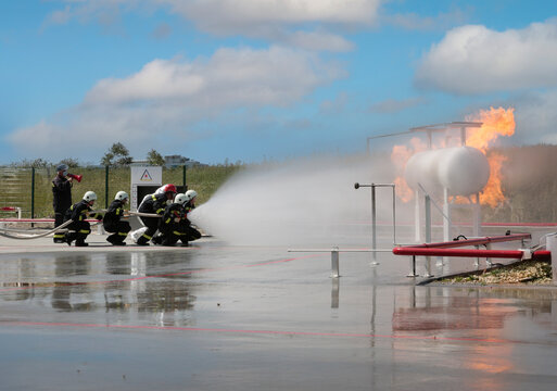 Fire extinguishing drill. Workplace workers conduct fire drills. 
