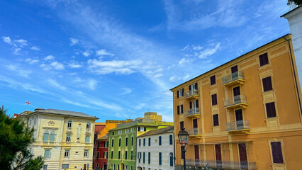 Vibrant Italian Architecture: A picturesque scene of colorful buildings against a backdrop of a bright blue sky, the architecture blends classic charm with vivid hues.