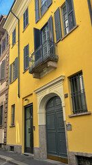 Golden Facade: A radiant, yellow-painted building in an old European city, showcasing exquisite architectural details, capturing history and elegance.
