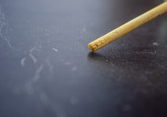 Close-up shot of wooden stick on dark background showing texture, suitable for backgrounds, or product design mockups, arts and crafts, and creative projects