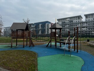 Urban Oasis Playground: A vibrant and inviting playground, featuring playful structures set against the backdrop of modern residential buildings. A place designed for fun.