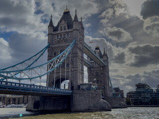 Stunning aerial view of Tower Bridge in London, spanning the River Thames with the city skyline in the background &mdash; blending historic architecture and modern urban beauty. London Bridge