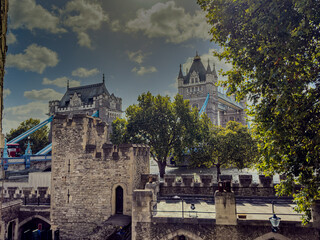 Stunning aerial view of Tower Bridge in London, spanning the River Thames with the city skyline in the background &mdash; blending historic architecture and modern urban beauty. London Bridge
