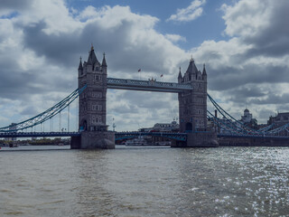 Stunning aerial view of Tower Bridge in London, spanning the River Thames with the city skyline in the background &mdash; blending historic architecture and modern urban beauty. London Bridge
