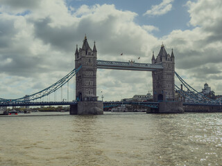 Stunning aerial view of Tower Bridge in London, spanning the River Thames with the city skyline in the background &mdash; blending historic architecture and modern urban beauty. London Bridge