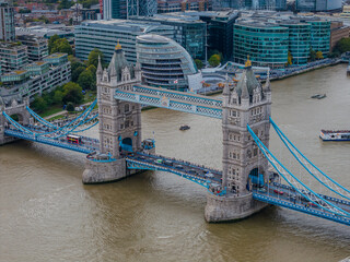 Stunning aerial view of Tower Bridge in London, spanning the River Thames with the city skyline in the background &mdash; blending historic architecture and modern urban beauty. London Bridge