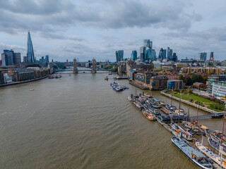 Stunning aerial view of Tower Bridge in London, spanning the River Thames with the city skyline in the background &mdash; blending historic architecture and modern urban beauty. London Bridge