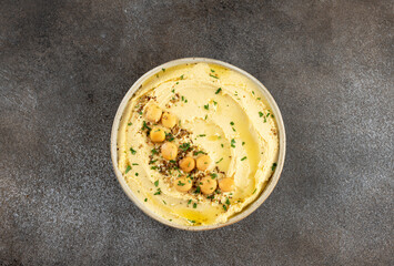 Lupini bean hummus with olive oil and herbs on gray background. Vegetarian food. Top view.