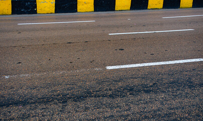 Drive forward safely on this highway road with bright road markings, ideal for travel, transportation, and infrastructure themes