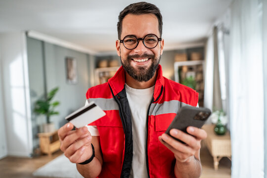Happy man shopping online holding credit card and smartphone