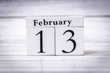 Display of a wooden calendar showing February 13, highlighting date significance, perfect for anniversary reminders. Ideal for lifestyle, planning, and personal events.