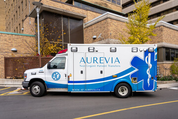 Fototapeta premium Toronto, ON, Canada - November 6, 2025: An Aurevia non urgent patient Transfers vehicle is seen in Toronto. Aurevia provides non urgent, scheduled patient transport. 