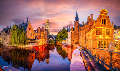 Sunset over Bruges with medieval architecture and peaceful canals in Belgium.