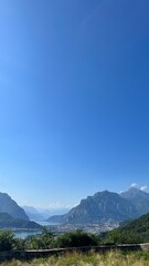 Azure Sky over Mountain Vista: Capture the vast expanse of a clear, cloudless sky meeting the rugged peaks of majestic mountains.