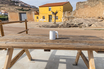 White electric kettle on the gray wooden table background