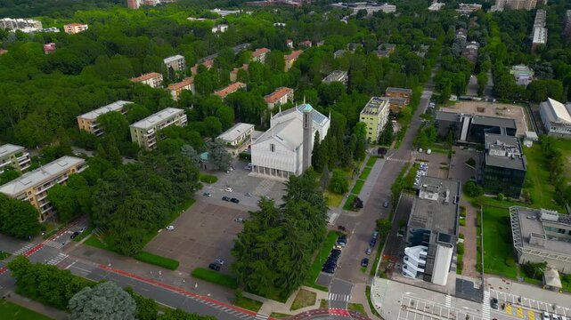 Aerial Cityscape San Donato Milanese, Italy: An eye-level aerial perspective unveils an urban tapestry, with a church at the heart of the scene and buildings that harmonize with nature.