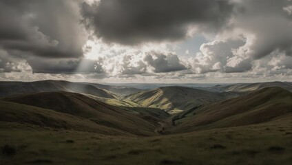 Dramatic view of rolling hills under a cloudy sky with sunbeams breaking through