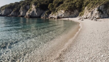 Serene beach with clear turquoise water, white pebbles, and cliffs covered in lush greenery
