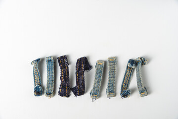 Belt loops from denim jeans on a white background, copy space