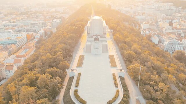 Witness the stunning beauty of Vitkov National Monument in Prague during sunrise. This historic site features the impressive equestrian statue of Jan Zizka surrounded by lush greenery.