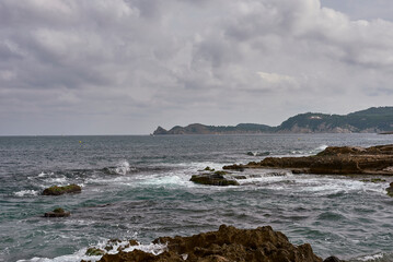 Coastal landscape with dark sea and clouds