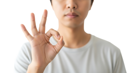 A person in a plain white t-shirt makes the OK hand gesture, communicating agreement and understanding with confidence.