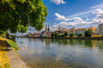 Panoramic view on beautiful Stone Bridge, Cathedral and Old Town. River Danube with colorful reflection, Regensburg, Bavaria, Germany. High quality photo