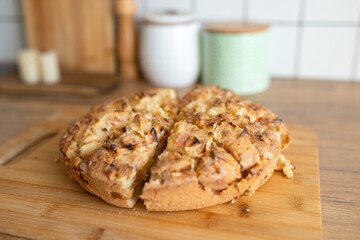 Freshly baked homemade apple pie on wooden board