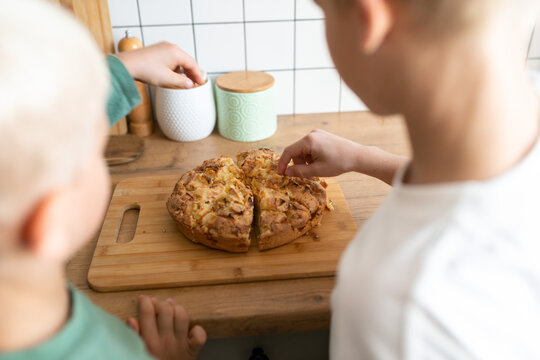 Kids enjoying freshly baked apple cake