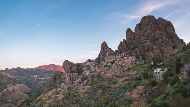 Time lapse: ancient village of Pentedattilo Calabria Italy built on rocky mountain slope at sunrise with dramatic cliffs and historic stone houses symbolizing heritage and Mediterranean culture